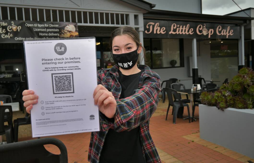 QUICK CUPPA: Little Cup Cafe barista Emelee Norris is reminding patrons to sign in with their QR codes upon entering the cafe. Picture: Kenji Sato