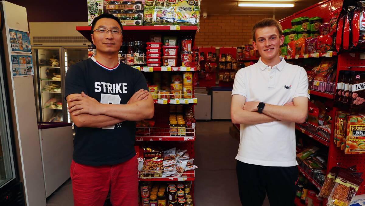 DREAM TEAM: Wojia shopkeeper Aiden Jie with his talented employee Noah Little. Picture: Emma Hillier