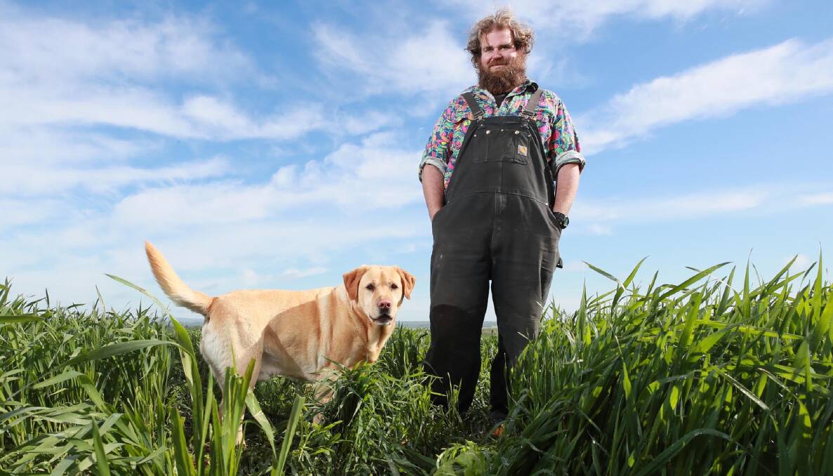 GROWTH: Simon Moloney and Brian the labrador are crossing their fingers for some rainy months ahead. Picture: Les Smith