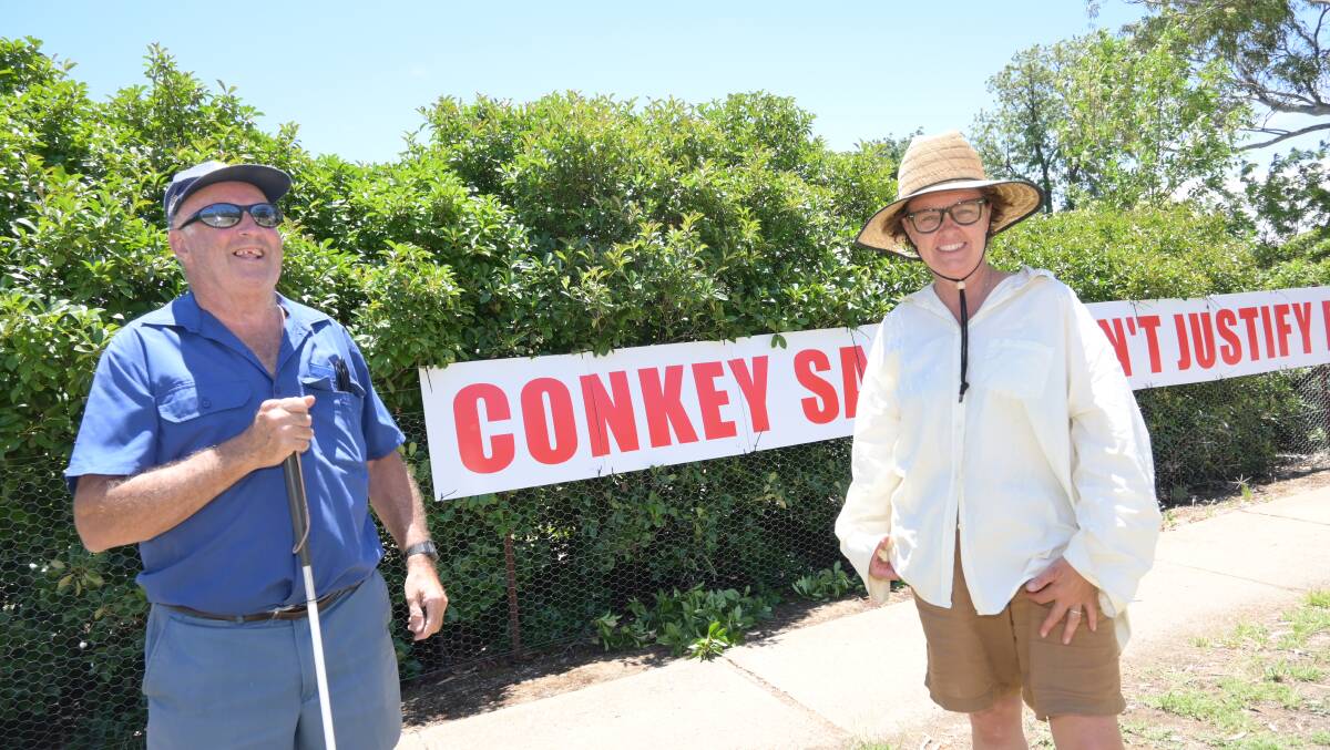 SIGN: Geoff Conway and Fiona Ziff have been plastering signs up and down North Wagga to send a clear message to council in general and the mayor in particular. Picture: Kenji Sato