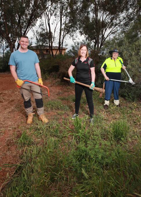GREEN THUMGS: Joel O'Loughlin, Jacinta Kelly and Milena Dunn are getting their hands dirty in order to clean up Kooringal's Rocky Hill Reserve. Picture: Les Smith