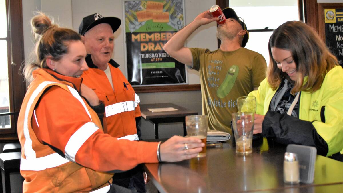 REJOICING: Rail sweepers Ash Fitzgerald, Craig Dohl, Simon Murray, Lindsay Barr knock off for a schooner after work. Picture: Kenji Sato