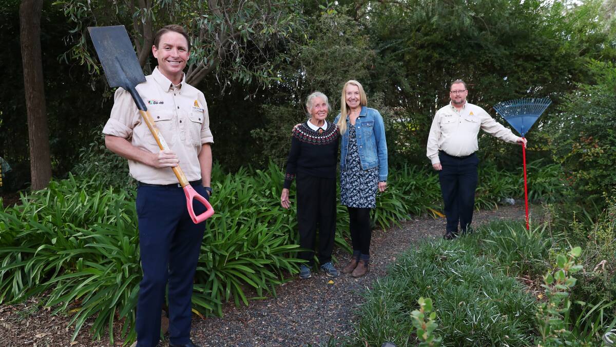 HANDY HELPERS: Joshua Paul (left) and Andrew Morrison (right) help Nel Grant and her daughter Ellen Schussler prune the hedges and do odd-jobs around the house. Picture: Emma Hillier