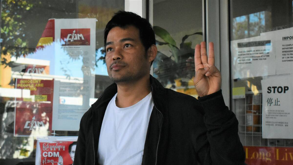 Phillip Kyaw stands in solidarity with the Myanmar protesters with the three finger salute, a symbol taken from the Hunger Games. Picture: Catie McLeod