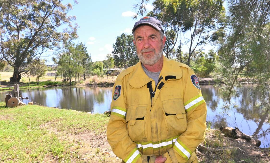 STAY SAFE: Firefighter Wayne Connors is reminding locals to stay flood-safe as dams become perilously close to full capacity. Picture: Kenji Sato