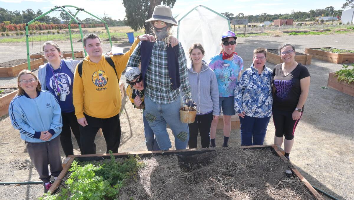 Kurrajong clients and Clive the scarecrow. Picture: Kenji Sato
