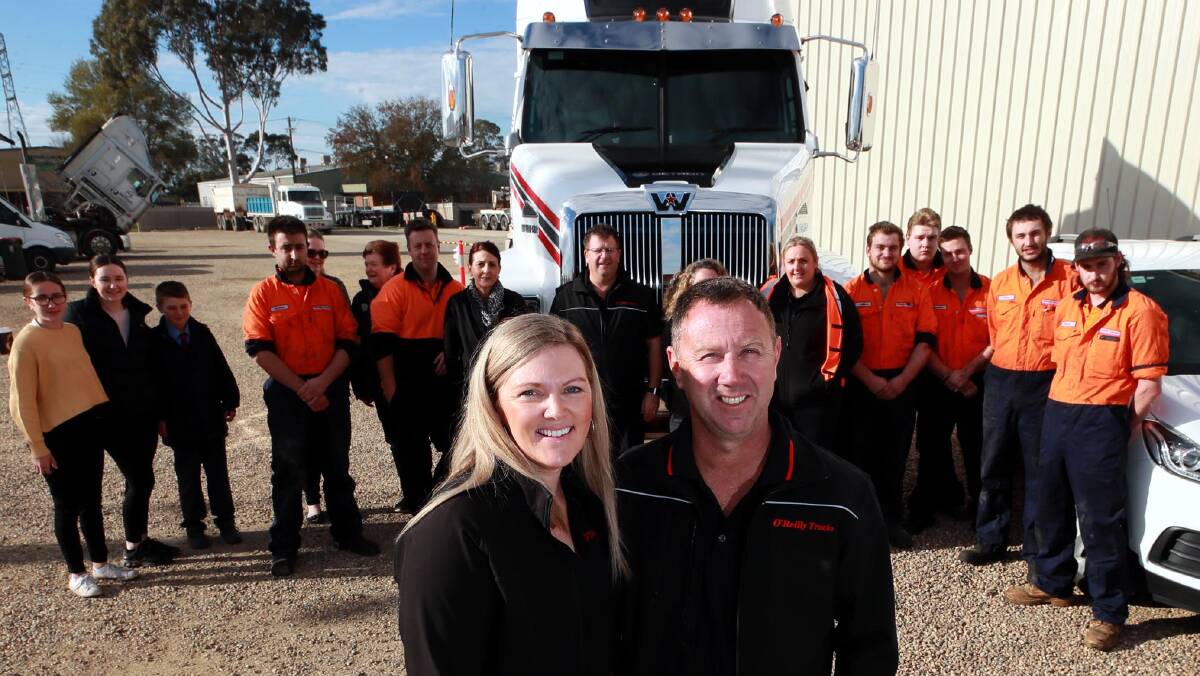 MILESTONE: Tracey O'Reilly and Brad O'Reilly celebrate the tenth anniversary of O'Reilly Trucks with "the boys". Picture: Les Smith