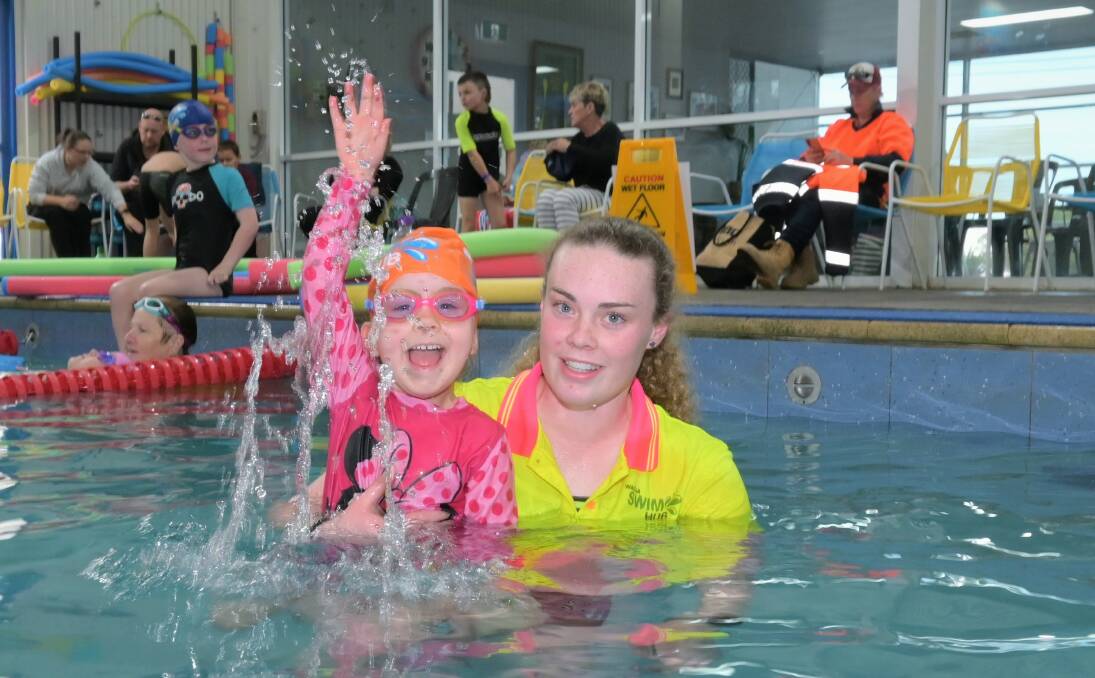 MAKING WAVES: Aurora Morison learns how to stay safe in the water with Wagga Swim Hub swimming instructor Anabella Storer. Picture: Kenji Sato
