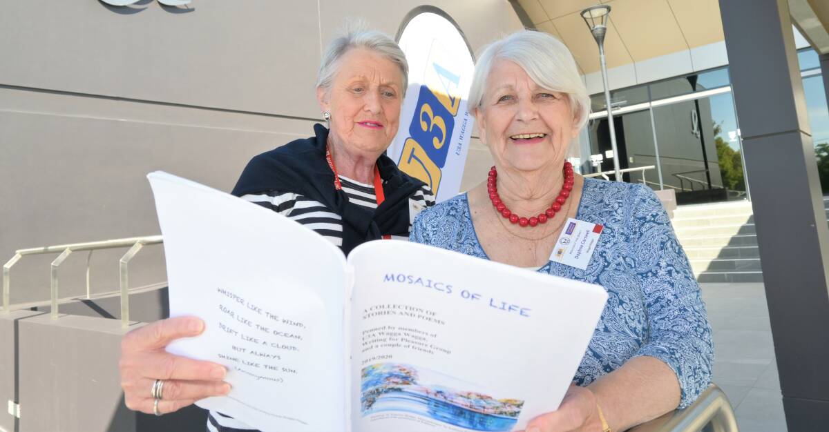 LOVERS OF LEARNING: Penny Bull and Daphne Carswell with an anthology of their members' writings. Picture: Kenji Sato