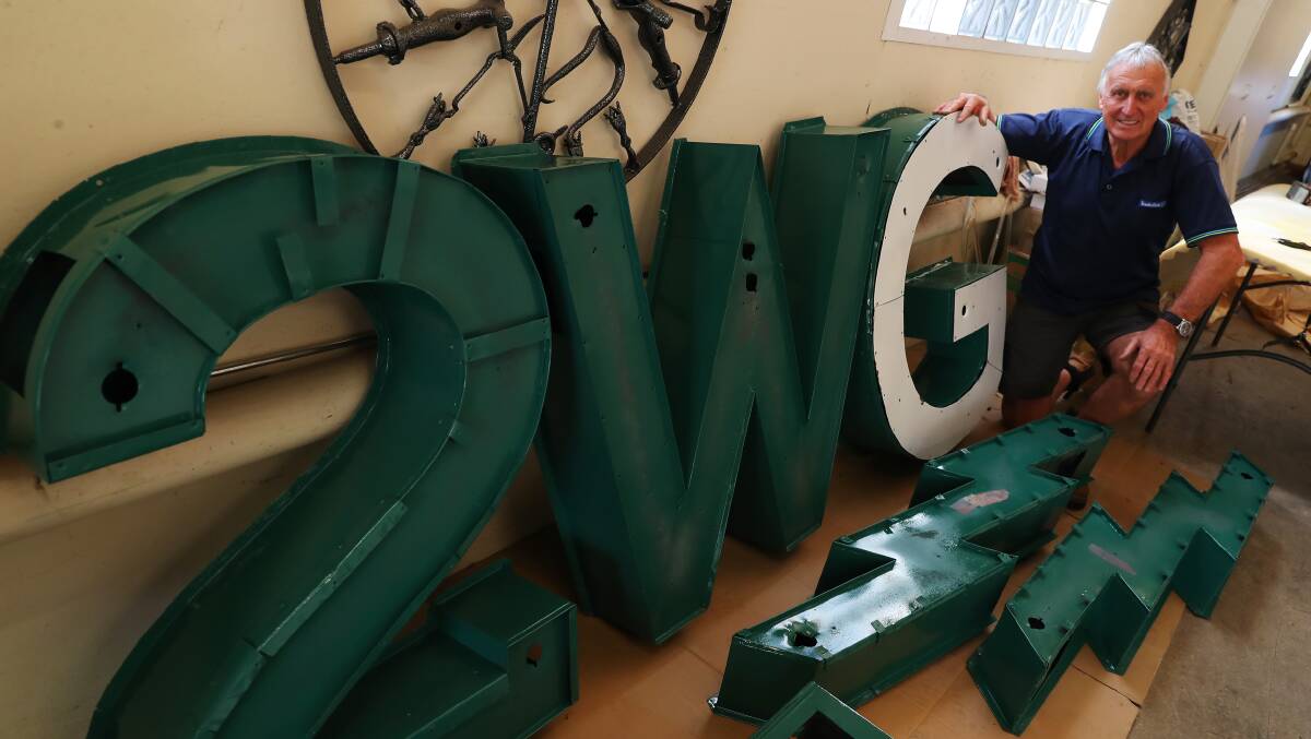LABOUR OF LOVE: Brian Hay has spent the last couple of weeks lovingly restoring the historic 2WG sign to its former glory. Picture: Emma Hillier