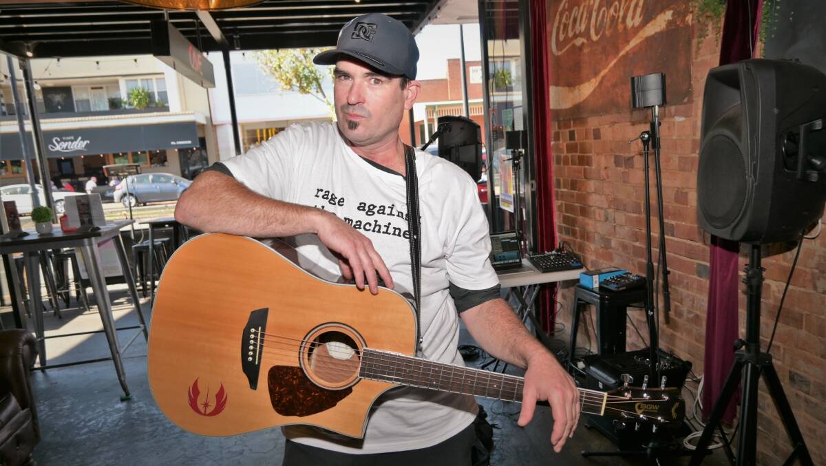FEELING PLUCKY: Wagga busker Rob Ratten strikes a chord with his audience at Fitz Fest, which was held up and down Fitzmaurice Street on Saturday. Picture: Kenji Sato