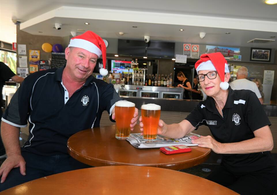 CHRISTMAS CHEERS: Bartender Damien "Damo" Laurent and Tracie Bate celebrate the news of restrictions easing with a beer. They hope to spend Christmas with family, provided the state borders open in time. Picture: Kenji Sato