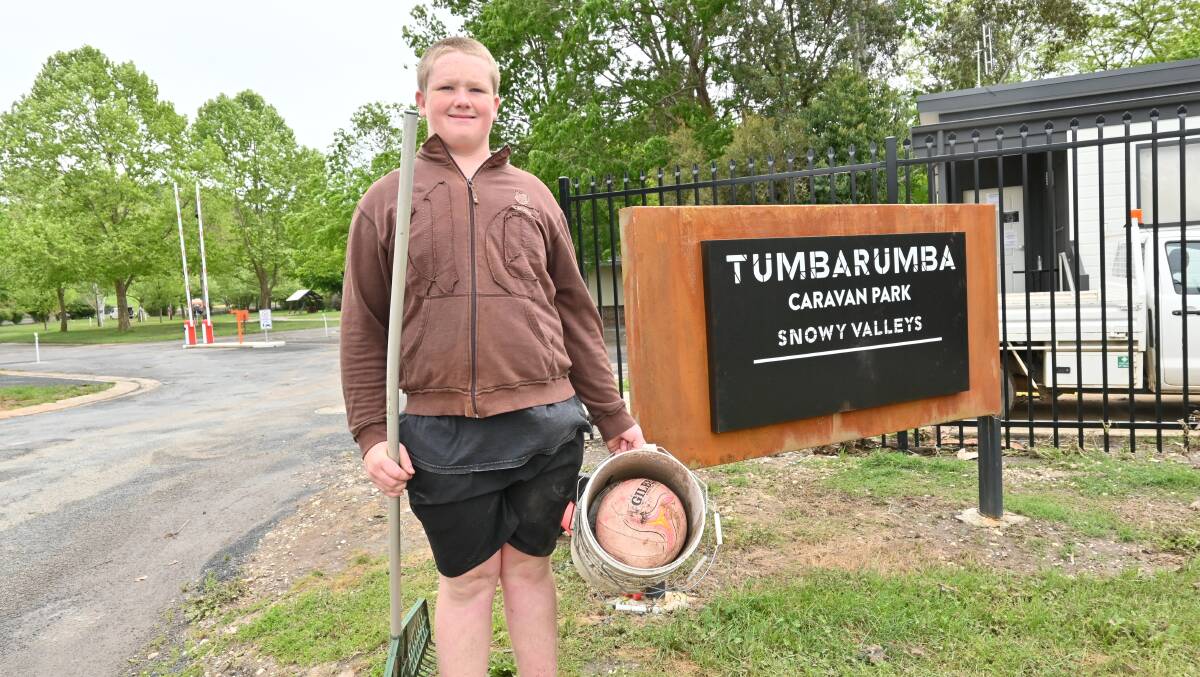 TUMBA TROOPER: Zac Morris spent the weekend rescuing fish and clearing up debris that had washed up on the Tumbarumba streets. Picture: Kenji Sato