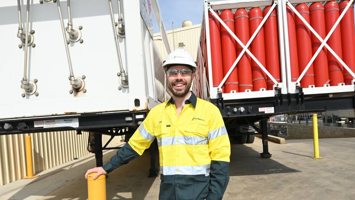 GOING GREEN: Engineer Thomas Goodwin and a truckload of hydrogen cylinders, which are shipped in every day from Queensland. Picture: Kenji Sato