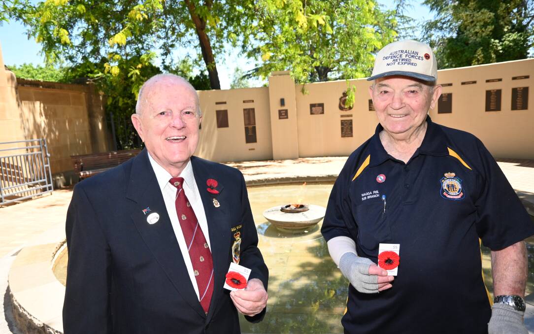 BURNING BRIGHTLY: Veterans Peter Randal, 91, and Alan Evans, 90, are out selling poppies in order to keep the Remembrance Day tradition alive in Wagga. Picture: Kenji Sato