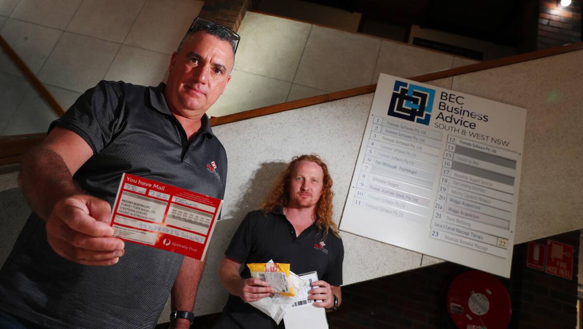 FIRE AND FURY: FireMate Software owner Brendan Appleby and worker Steven Johnston are enraged at Australia Post. Picture: Emma Hillier