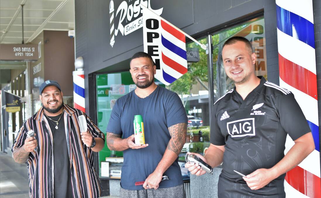 STILL OPEN: Ross C's barbers Cameron Anthony, Jason Lagaali, and Ross Clay are happy to be able to hold onto their jobs - at least for the time being. Picture: Kenji Sato