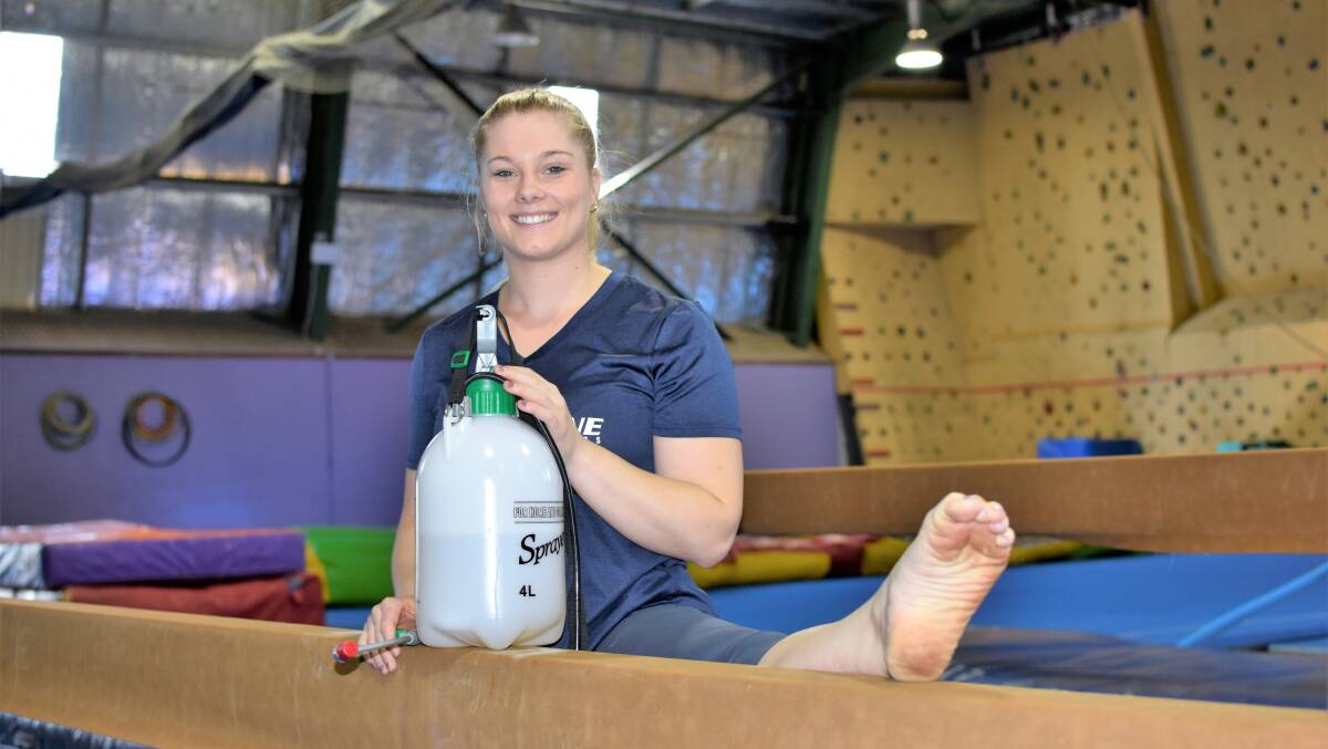 SPRAY AND PRAY: Airborne Gymnastic head coach Christina Judd has been meticulously spraying down all of the mats and gymastics equipment. Picture: Kenji Sato