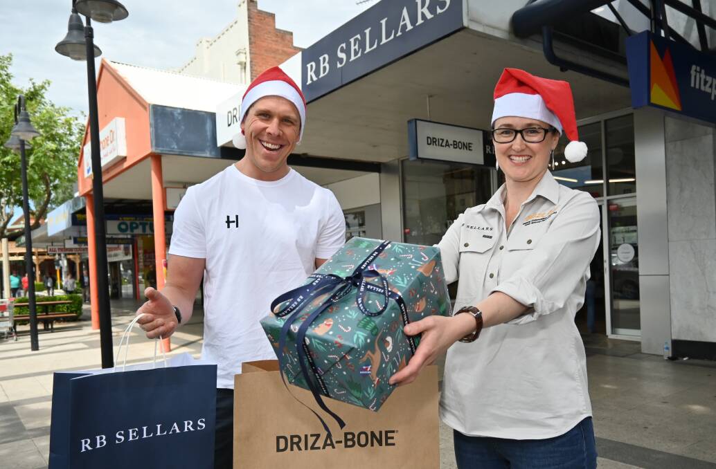 MERRY MAKERS: Rhyley Hunter and Liz Cronin are asking shoppers to help out local shopkeepers this Christmas by buying their presents within Wagga. Picture: Kenji Sato
