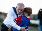 Prime Minister Scott Morrison crashes into Luca Fauvette during an under 8s soccer training session in Devonport. Picture: Eve Woodhouse