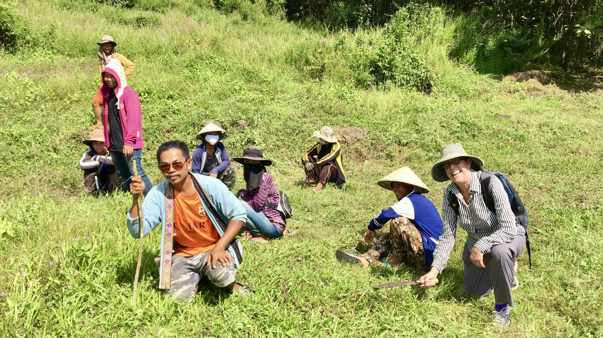 Prof Deirdre Lemerle and farmers cut weeds for animal fodder in southern Laos in 2018. Picture supplied