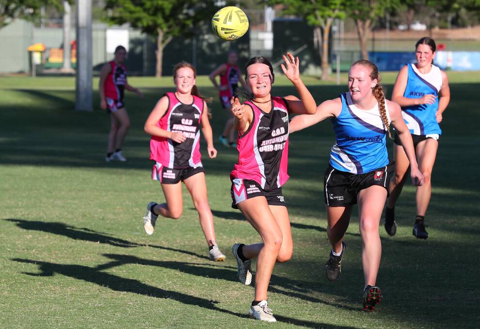 CATCH: Young Guns' Bronte Prestage fires off a pass during her side's narrow loss to AKW Jets during last week's women's Premier League action. Picture: Kieren L Tilly