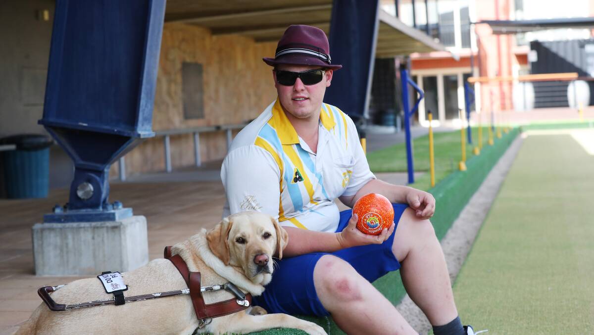 CHAMPION: Wagga artist Joel Jensen, 21, with his guide dog Nicci, at the RSL preparing for the game. Picture: Emma Hillier