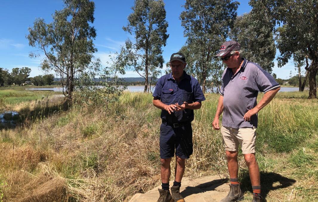 FRUSTRATION: Lake Albert advocates Mick Henderson and Gary Gurtner discuss the lake's water levels in front of a weir near Tatton Drain. Picture: Catie McLeod