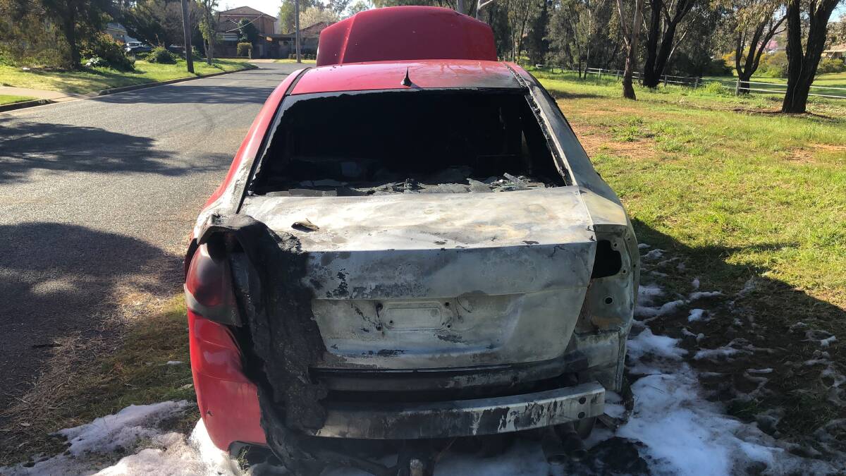 The Holden sedan was left severely damaged and doused in firefighting foam. Picture: Catie McLeod