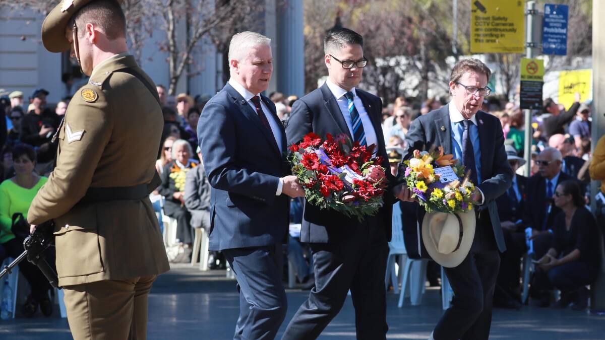 CALL OUT: Michael McCormack, Wagga-based MLC Wes Fang and Wagga MP Joe McGirr lay wreaths on Anzac Day. Picture: Les Smith