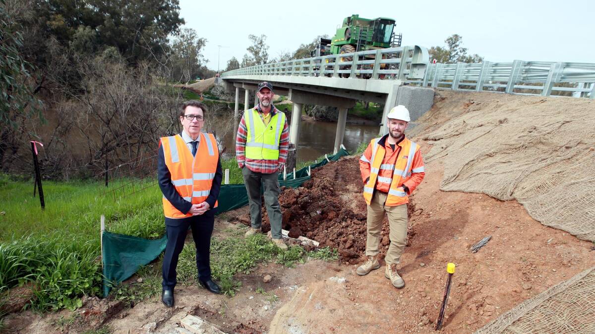 AT LAST: State member for Wagga Joe McGirr, with Council's Matthew Casley and project manager Damian McConville at the bridge as a vehicle drives over it. Picture: Les Smith
