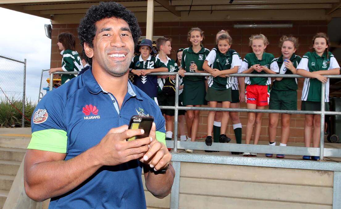 MEET AND GREET: Canberra Raider Sia Soliola with catches up with some young fans at yesterday's Mortimer Shield. Picture: Les Smith