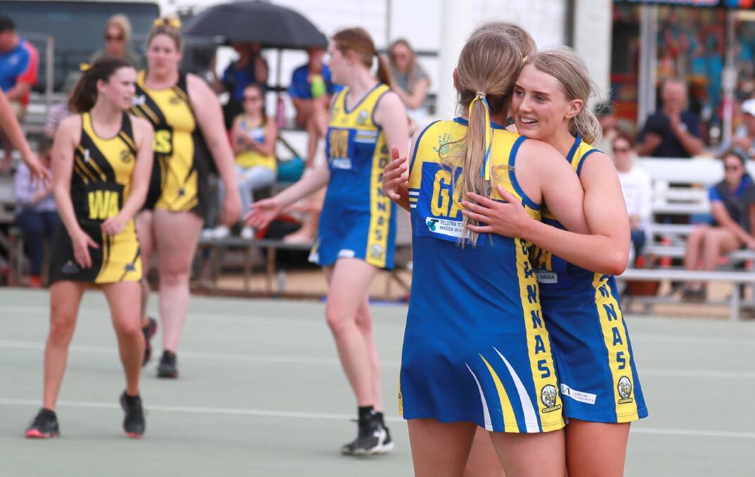 TITLE DEFENCE: MCUE players celebrate after winning the AFL Riverina Championships grand final over Wagga Tigers. Picture: Les Smith