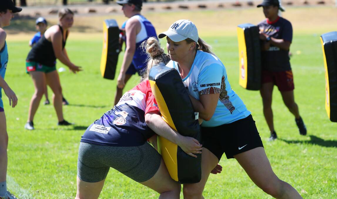 MUSCLING UP: Shannon Pike gets in some practice on the tackling bags during the Riverina women's tackle team's training on Saturday. Picture: Emma Hillier
