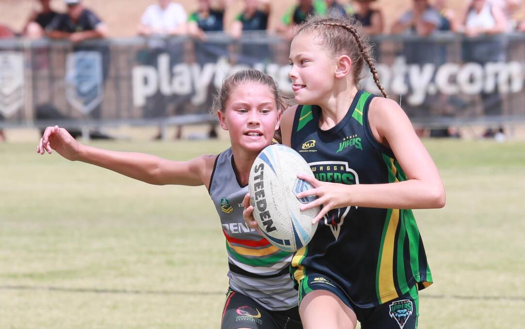 FINALS TIME: Wagga Viper Stephanie Charlton tries to evade a Penrith rival in the under-12 girls final at the Junior State Cup Southern Conference at Jubilee Park on Sunday. Picture: Les Smith 