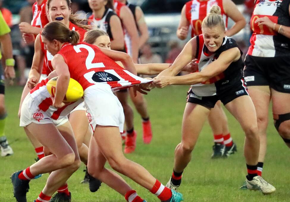 TOUGH: CSU's Gabrielle Goldsworthy tries to shake a tackle from North Wagga's Olivia- Lee Hounsell in last year's grand final. Picture: Les Smith
