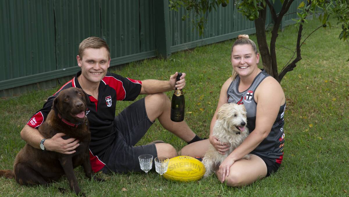 BUSY WEEK: North Wagga coach Brayden Skeers and skipper Kelsey Leaver with dogs Millie and Teddy. Picture: Madeline Begley