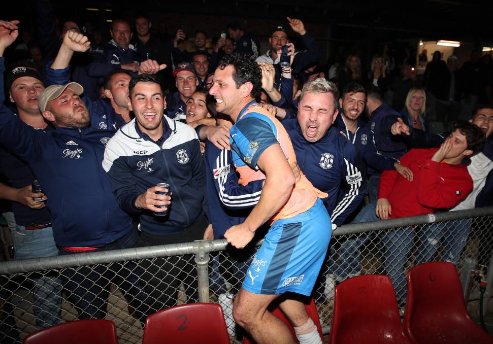 GOOD TIMES: Hanwood's Joey Schirripa celebrates with Hanwood fans after guiding his team to a grand final win over Lake Albert. Picture: Les Smith