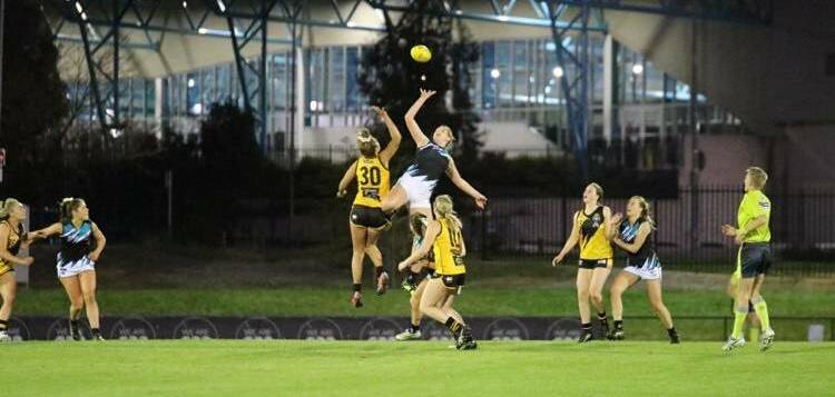 STANDOUT: Ally Morphett (Teal and black) in action for Belconnen during their AFL Canberra grand final win. 