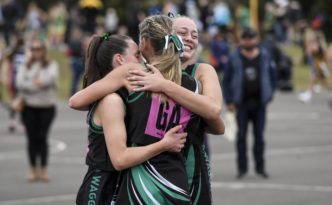 WINNING FEELING: Wagga's under-17s Caitlin Wheeler, Claudia Wheatley and Ash Reynoldson embrace after their success at the state netball titles. Picture: Nigel Owen/Netball NSW