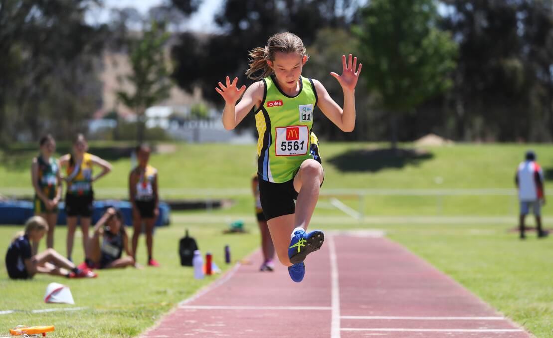 BIG DAY: Nine year old Charli Speers launches off during the long jump competition at the Wagga Wagga Little Athletics Carnival on Sunday. Picture: Emma Hillier