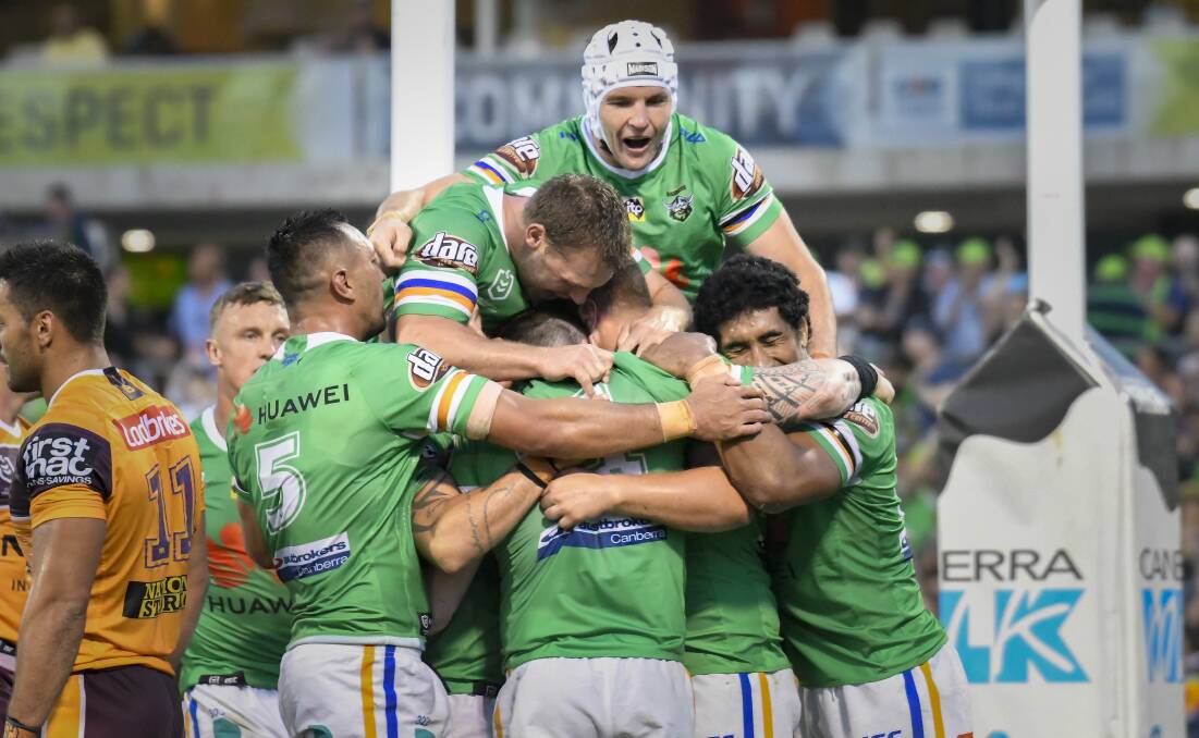 FLYING START: The Raiders celebrate a try during their win over Brisbane. Photo: Sitthixay Ditthavong