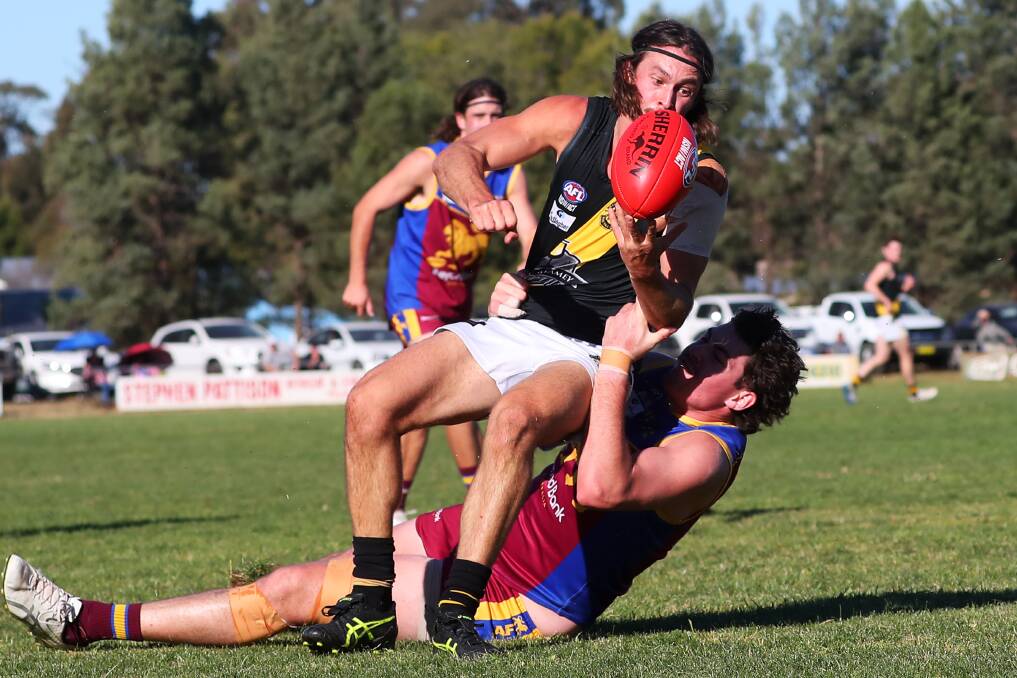 HALFWAY MARK: Tiger Reid Gordon tries to slip a tackle from Ganmain-Grong Grong-Matong's Riley Corbett earlier this year. Picture: Emma Hillier