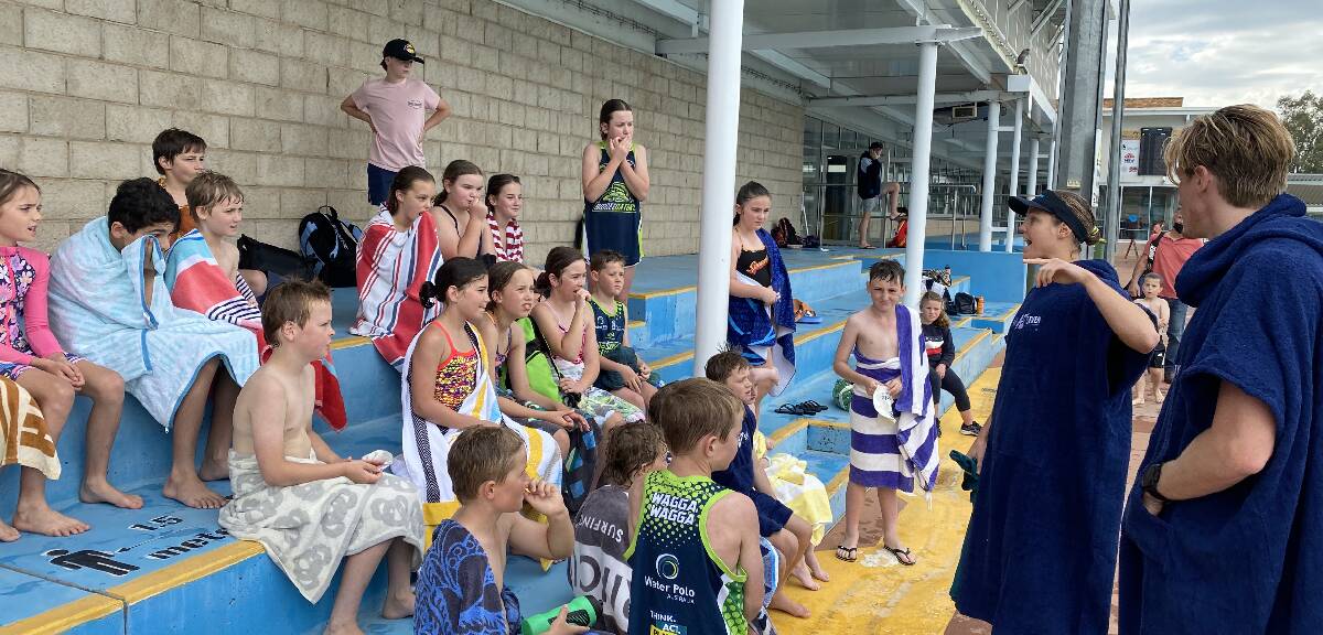 FULL ATTENTION: Wagga Water Polo juniors gets some tips from Olympian Keesja Gofers. 