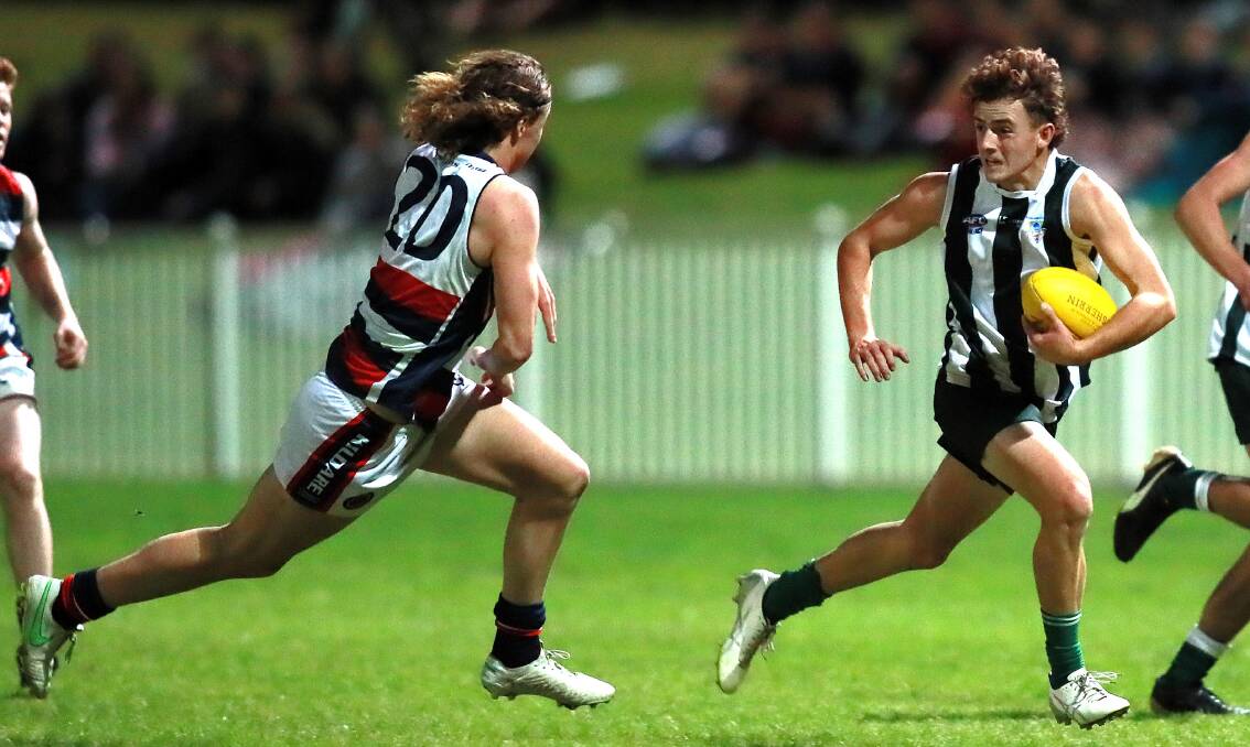 TOO GOOD: The Riverina Anglican College's Sam McNaughton tries to evade Kildare Catholic College's Joe Morton at Robertson Oval on Wednesday night. Picture: Les Smith