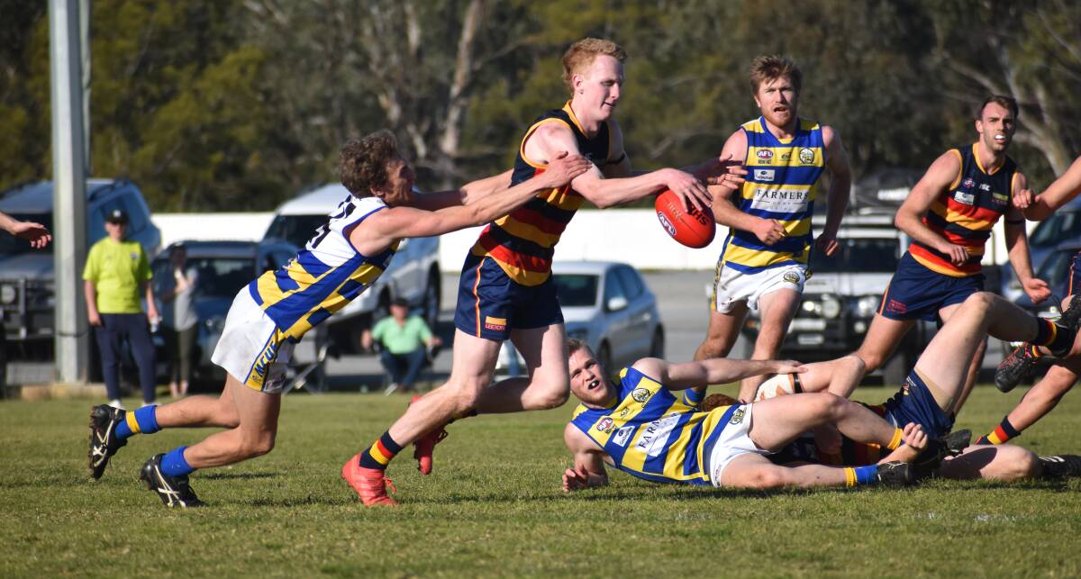 TOO STRONG: Leeton-Whitton's Sam Hopper gets a kick away during Saturday's win over MCUE. Picture: Liam Warren