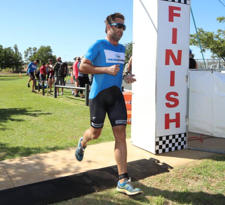NO SWIM: West Wyalong's Angus Westaway crosses the finish line to win last year's Temora Triathlon. Picture: Les Smith