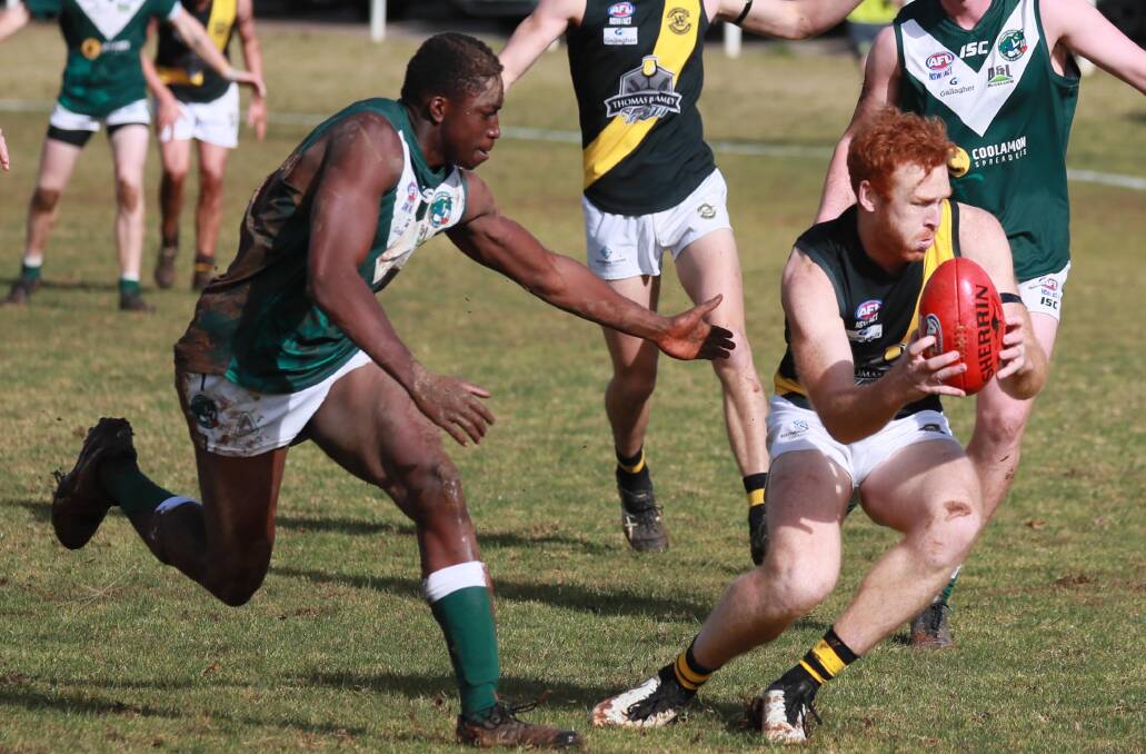 CLOCK TICKING: Wagga Tiger Murray Stephenson and Coolamon's Gerard Okerenyang in action earlier this season. Picture: Les Smith