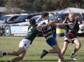 TIGHT TUSSLE: MCUE's Ethan Schiller is tackled by Coolamon's Braeden Glyde at Mangoplah Sportsground on Saturday. Picture: Madeline Begley