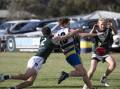 TIGHT TUSSLE: MCUE's Ethan Schiller is tackled by Coolamon's Braeden Glyde at Mangoplah Sportsground on Saturday. Picture: Madeline Begley